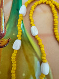 Yellow beaded necklace with pink opal beads.